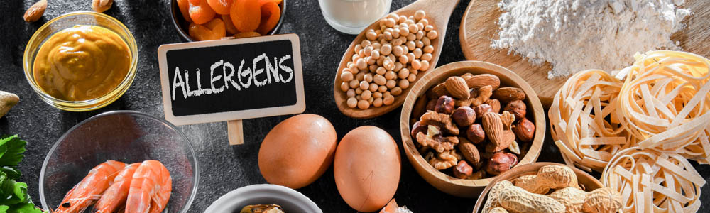 Main allergens - including nuts, eggs, and mustard - on a black counter Main allergens - including nuts, eggs, and mustard - on a black counter